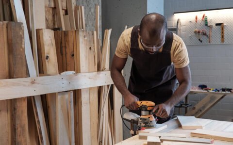 carpenter-sanding-wood-workshop